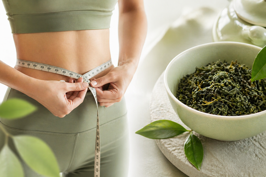 Tea and balanced lifestyle concept with oolong tea and waist measurement for wellness